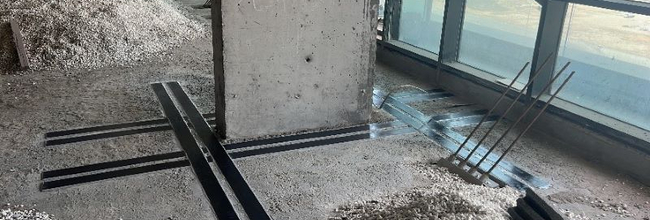 External PT for floor slab strengthening in a building being renovated
